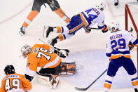 New York Islanders center Jean-Gabriel Pageau (44) flies over Philadelphia Flyers goaltender Carter Hart (79) during the first period of an NHL Stanley Cup Eastern Conference playoff hockey game in Toronto, Ontario, Tuesday, Sept. 1, 2020. (Frank Gunn/The Canadian Press via AP)