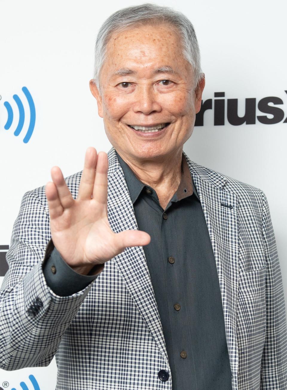 George Takei holding up the Star Trek sign