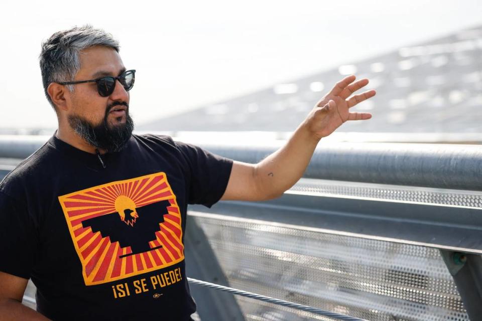 Isael Mejia explains the dangers construction people face when they work at great heights while observing construction at Charlotte Douglas International Airport on Tuesday, May 16, 2024. 