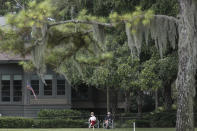 Residents sit in their yard to watch the first round of the RBC Heritage golf tournament, Thursday, June 18, 2020, in Hilton Head Island, S.C. (AP Photo/Gerry Broome)