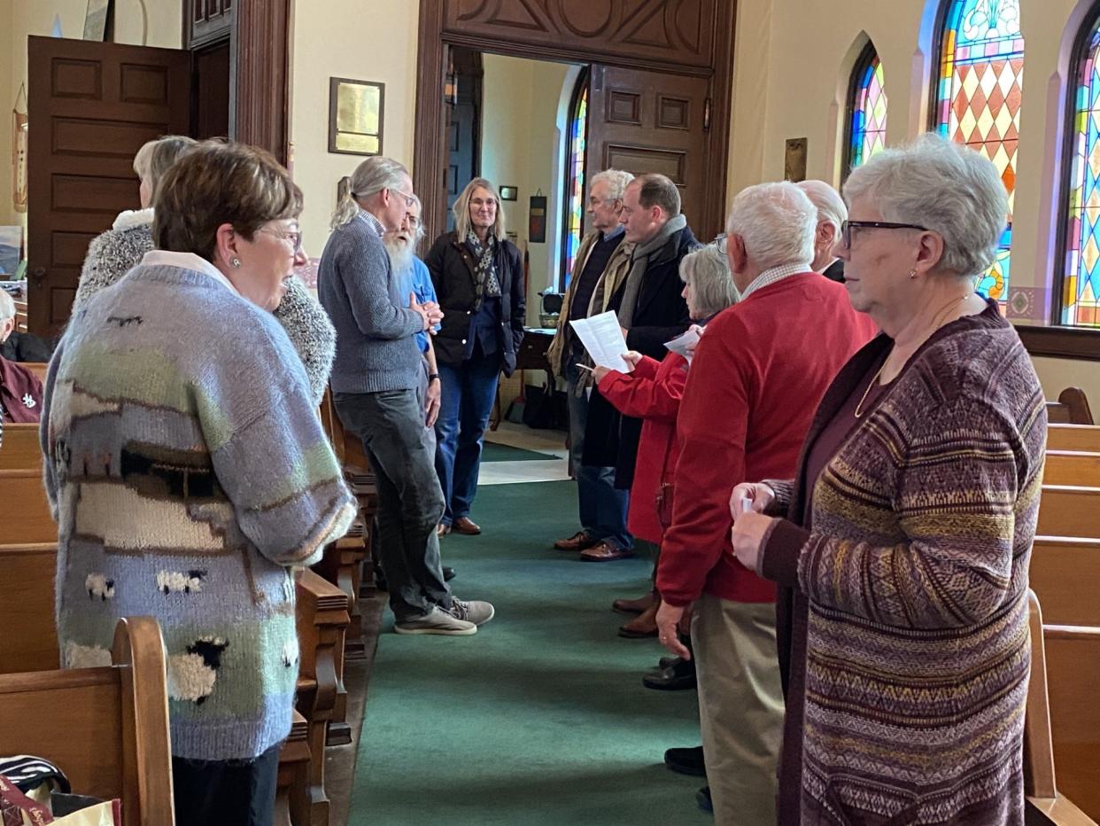 Rehoboth Welsh Chapel congregants gather near the entry to welcome those worshipping at the chapel in late January. Rhys ab Owen talks with the congregants.