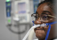 LaTanya Robinson pauses while talking about her ongoing recovery from COVID-19 inside the Coronavirus Unit at United Memorial Medical Center, Monday, July 6, 2020, in Houston. Robinson says she was caring for her son when he got the virus. Both she and her husband eventually caught it. While her son and husband's symptoms were relatively mild, she went from feeling tired and struggling to move to hardly being able to breathe. (AP Photo/David J. Phillip)