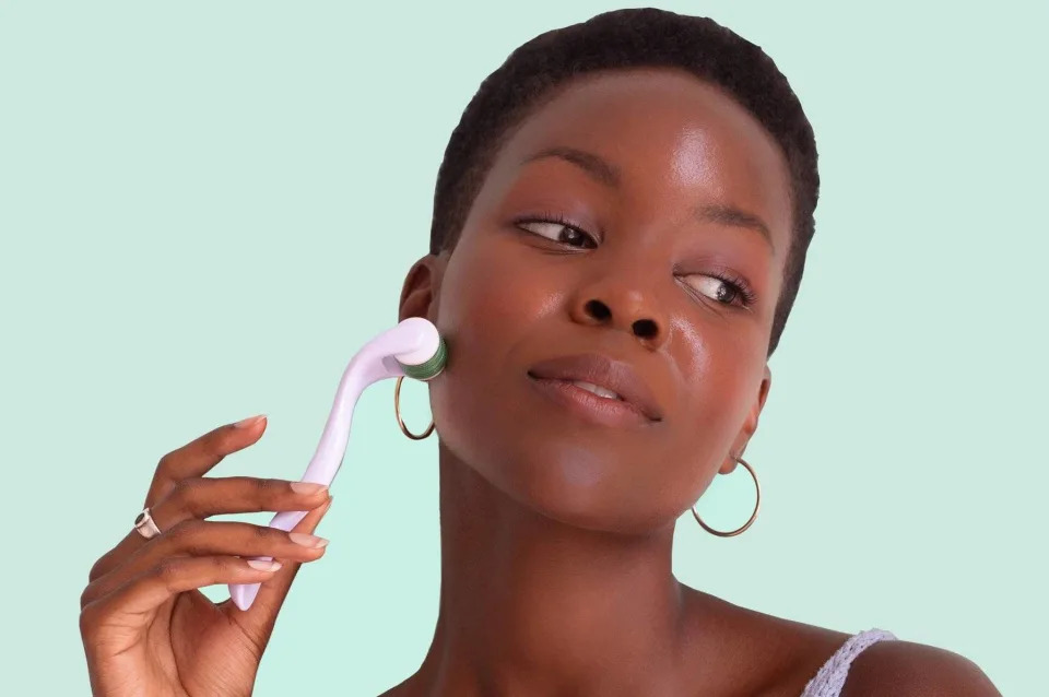 Closeup of woman using Sdara Skincare Derma Roller on her cheek