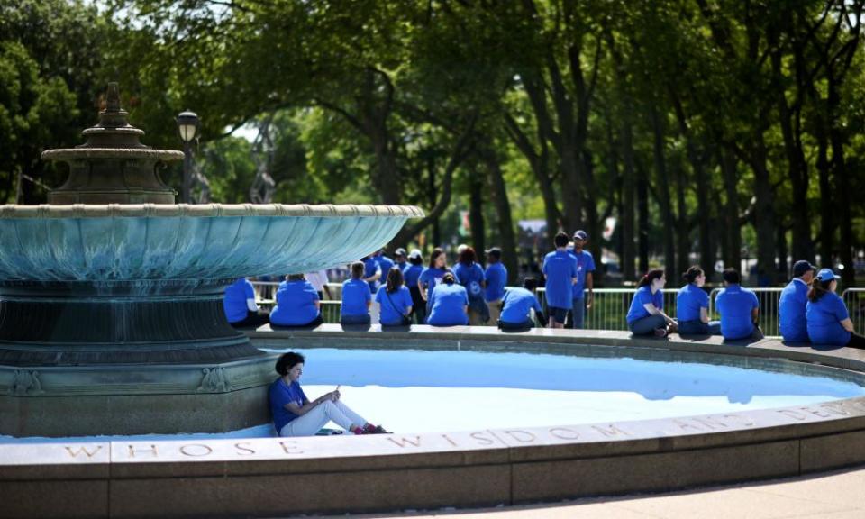 Campaign volunteers seek shade before the kickoff rally for Joe Biden in Philadelphia.