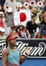 Supporters wave Japanese flags and fans as Japan's Naomi Osaka celebrates after winning her second round match against Ukraine's Elina Svitolina at the Australian Open tennis tournament at Melbourne Park, Australia, January 21, 2016. REUTERS/Issei Kato