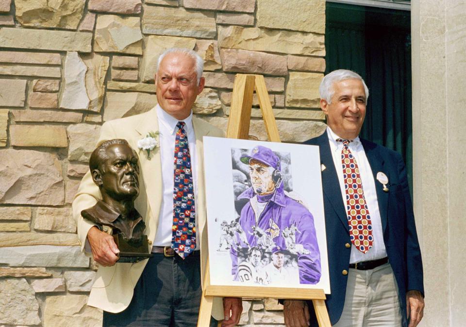 Pro Football Hall of Famer Bud Grant, former head coach of the Minnesota Vikings, holds his Hall of Fame bust and stands by his portrait in Canton, July 30, 1994.