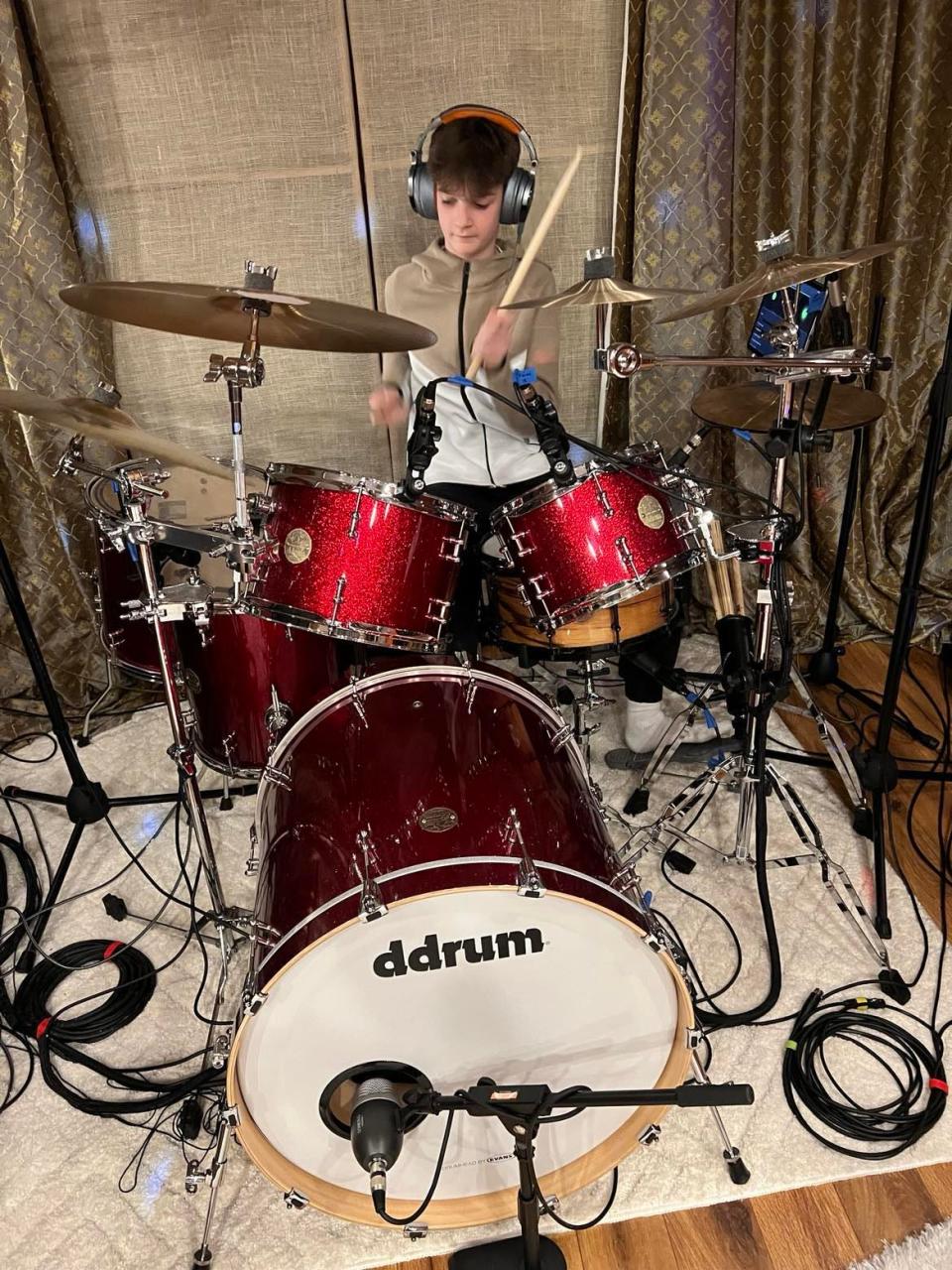 Johnny Kefalas plays drums during a rehearsal with the pop rock band COMPASS, which includes his brother Harrison and sister Arianna. The Jackson Township group will perform on Feb. 3 in the 27th annual Tri-C High School Rock Off at the Rock & Roll Hall of Fame in Cleveland.