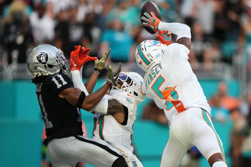 Miami Dolphins cornerback Jalen Ramsey (5) intercepts the a pass intended for Las Vegas Raiders wide receiver Tre Tucker.