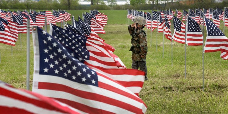 Randy Long Jr., then 8, views the hundreds of American flags displayed in the field at the River Raisin National Battlefield Park in 2019. Long saluted the flags dressed in his army fatigues.
This year’s display at the battlefield will run May 20 through June 3.