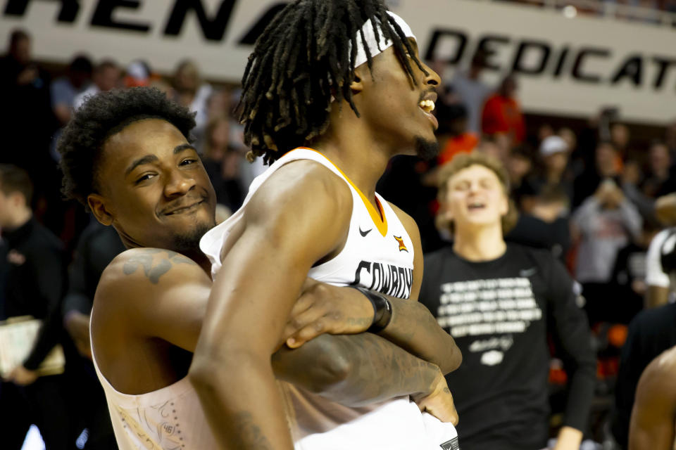 Oklahoma State's Kalib Boone (22) and Caleb Asberry (5) celebrate after the NCAA college basketball game against Iowa State in Stillwater, Okla., Saturday, Jan. 21, 2023. (AP Photo/Mitch Alcala)