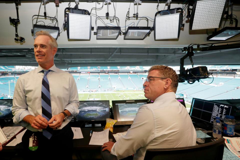 Joe Buck, left, and Troy Aikman work in the broadcast booth before a preseason NFL football game in 2019 between the Miami Dolphins and Jacksonville Jaguars. The pair called games for 20 years together on Fox before moving to ESPN for this season.