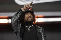 Washington cornerback Kyler Gordon points after being selected by the Chicago Bears during the second round of the NFL football draft Friday, April 29, 2022, in Las Vegas. (AP Photo/Jae C. Hong)
