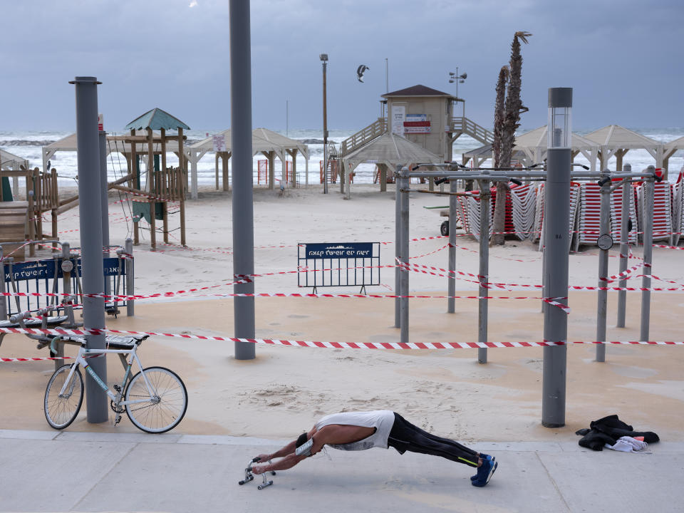 This Thursday, March 19, 2020 photo shows a free gym at Tel Aviv's beachfront wrapped in tape to prevent public access. Israel has reported a steady increase in confirmed cases despite imposing strict travel bans and quarantine measures more than two weeks ago. Authorities recently ordered the closure of all non-essential businesses and encouraged people to work from home. (AP Photo/Oded Balilty)