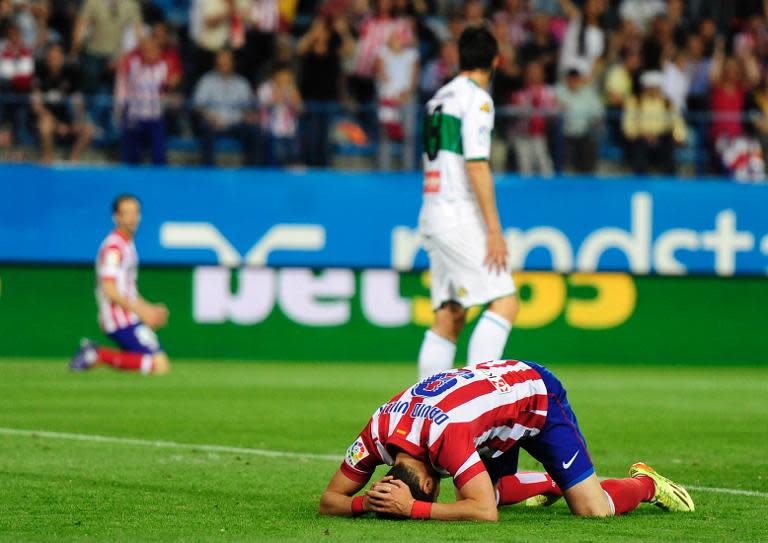 Atletico Madrid's forward David Villa reacts during a Spanish league football match against Elche at the Vicente Calderon stadium in Madrid on April 18, 2014