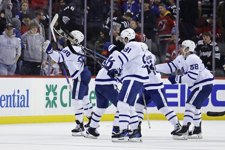 Toronto Maple Leafs right wing William Nylander (88) knocks down a canned beverage thrown by a spectator after the team's NHL hockey game against the New Jersey Devils on Wednesday, Nov. 23, 2022, in Newark, N.J. The Maple Leafs won 2-1. (AP Photo/Adam Hunger)