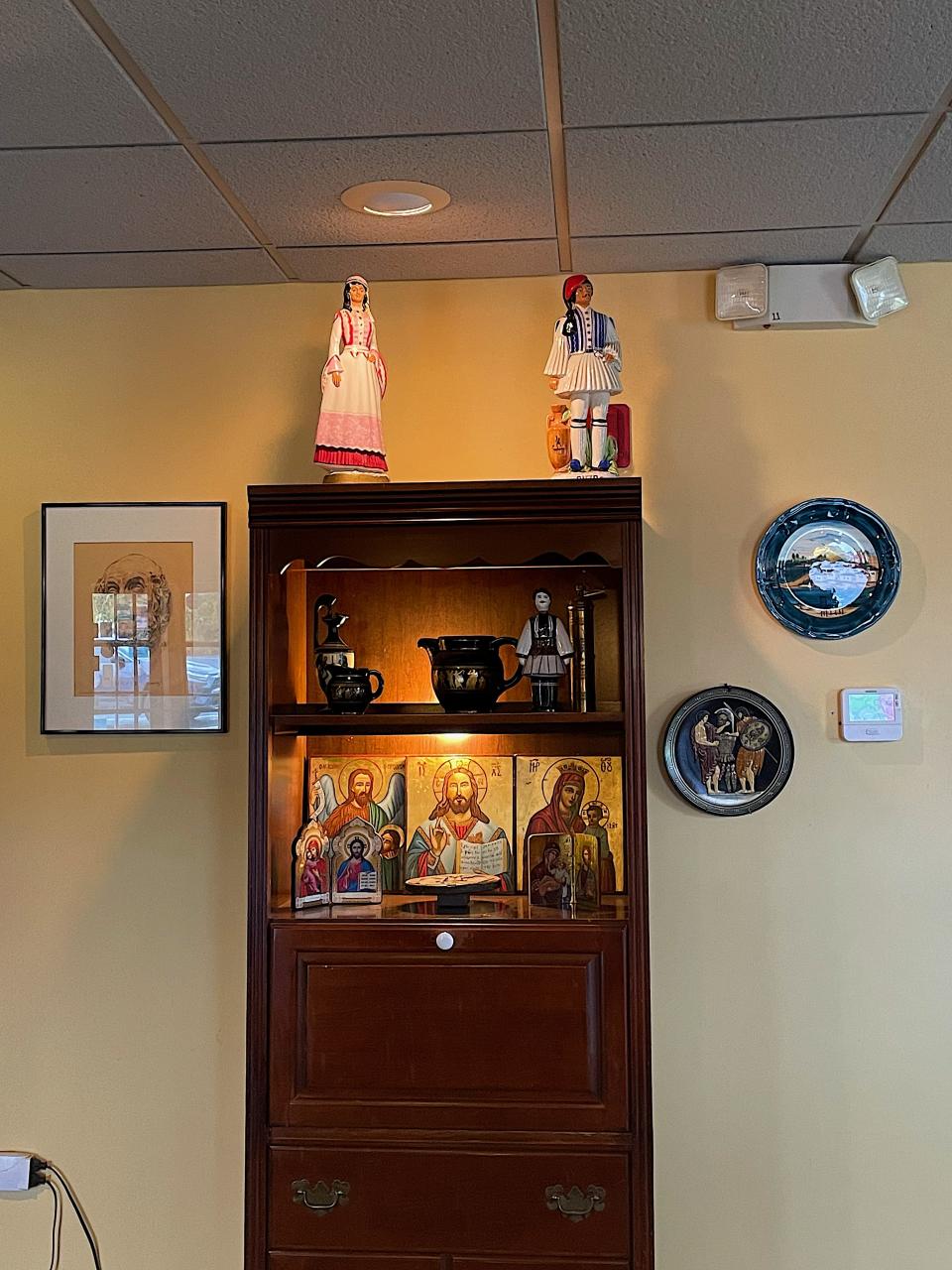 The decor at Symeon's Greek Restaurant in Yorkville includes figurines made of old Greek liquor bottles and plates, paintings and drawings donated by customers.