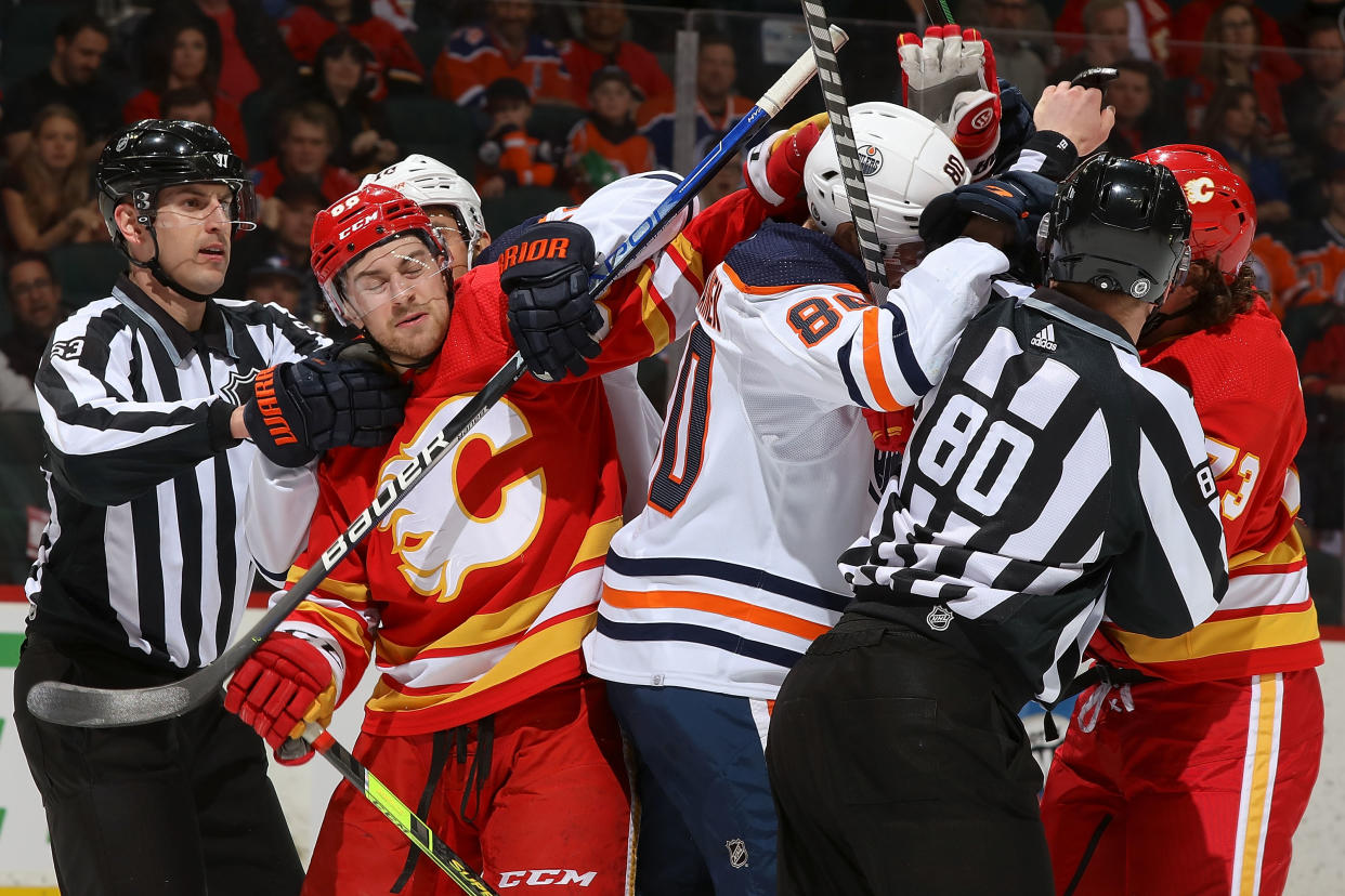 CALGARY, AB - MARCH 7: Andrew Mangiapane #88 of the Calgary Flames battles after the whistle against Markus Niemelainen #80 of the Edmonton Oilers at Scotiabank Saddledome on March 7, 2022 in Calgary, Alberta, Canada. (Photo by Gerry Thomas/NHLI via Getty Images)