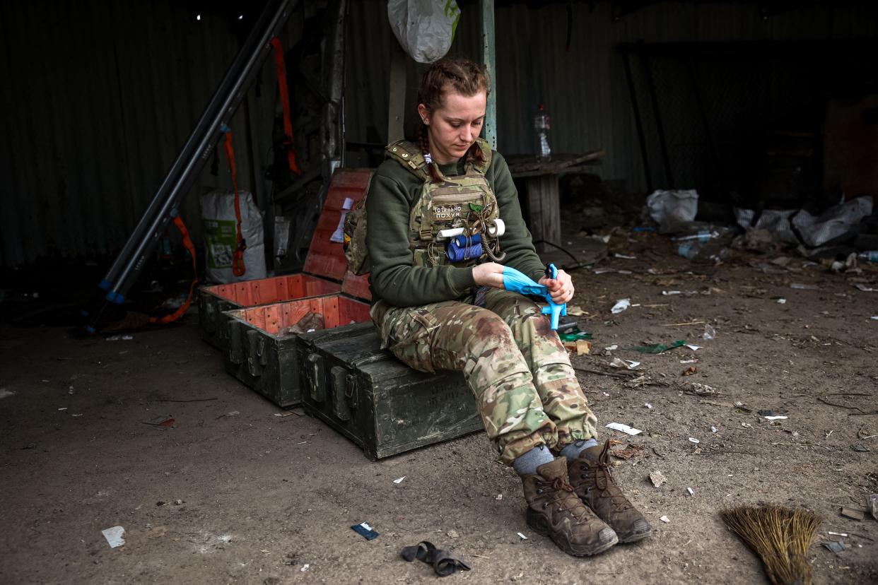A medic takes off her gloves at a frontline medical stabilisation point near Bakhmut, Donetsk region (AFP via Getty Images)