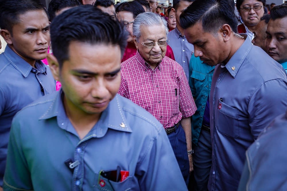 Prime Minister Tun Dr Mahathir Mohamad (centre) leaves after attending the Chinese New Year Open House hosted by Gerakan at the PGRM Tower in Kuala Lumpur January 25, 2020. — Picture by Hari Anggara