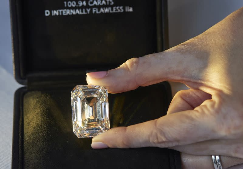 A staff holds a rectangular step-cut diamond of 100.94 carats during a preview at Christie's in Geneva