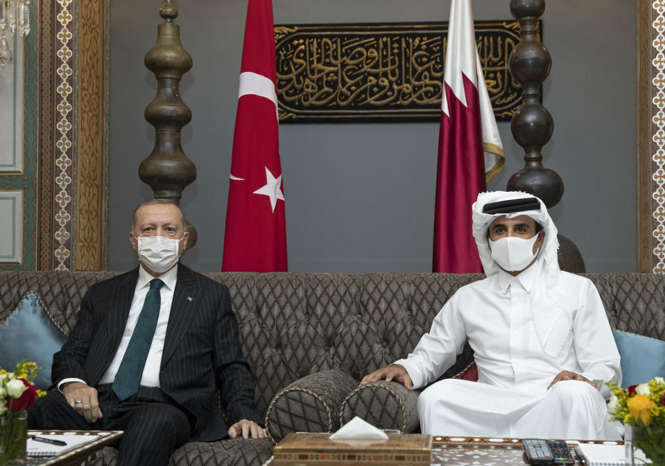 In this photo released by the Qatar Amiri Diwan, Turkish President Recep Tayyip Erdogan, left, poses with the Emir of Qatar Sheikh Tamim bin Hamad Al Thani, in Doha, Qatar, Wednesday, Oct. 7, 2020. (Qatar Amiri Diwan via AP)