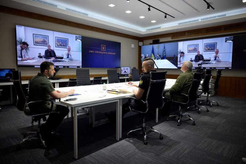 Ukraine's President Zelenskiy speaks with representatives of the BAE Systems via video call in Kyiv