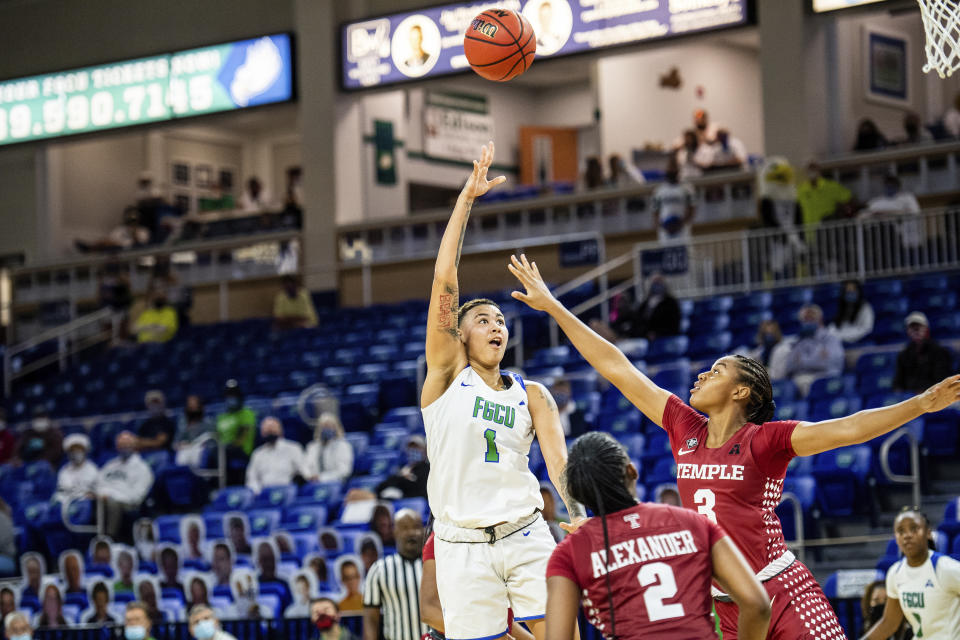 In this photo provided by Florida Gulf Coast University (FGCU) Kierstan Bell (1) goes up for a shot against Temple, Dec. 6, 2020 in Fort Myers, Fla. FGCU transfer Bell is fifth in the nation in scoring at more than 25 points per game, and has the Eagles poised for another run at the NCAA tournament. (Brad Young/Florida Gulf Coast University via AP)