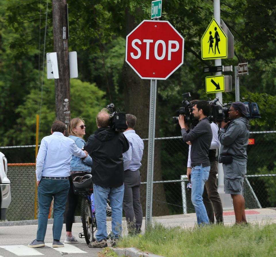 Media members are seen outside Little Harbour School in Portsmouth Tuesday, May 31, 2022, reporting about the shooting death of a third-grade student over the weekend in South Carolina.