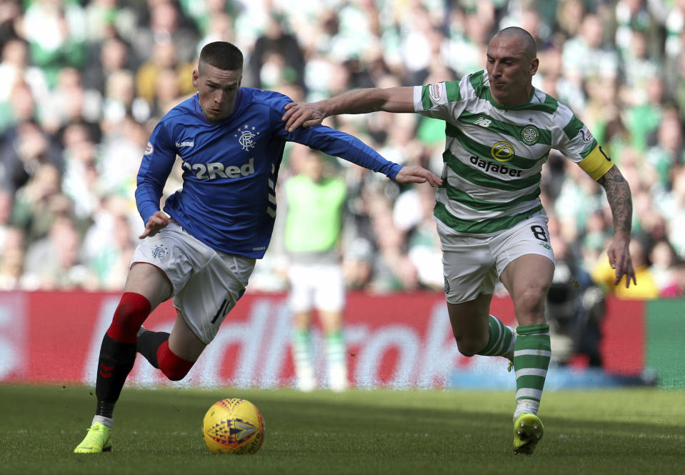 Rangers' Ryan Kent challenges with Celtic's Scott Brown, right, during their Scottish Premiership soccer match at Celtic Park in Glasgow, Scotland, Sunday March 31, 2019. (Andrew Milligan/PA via AP)