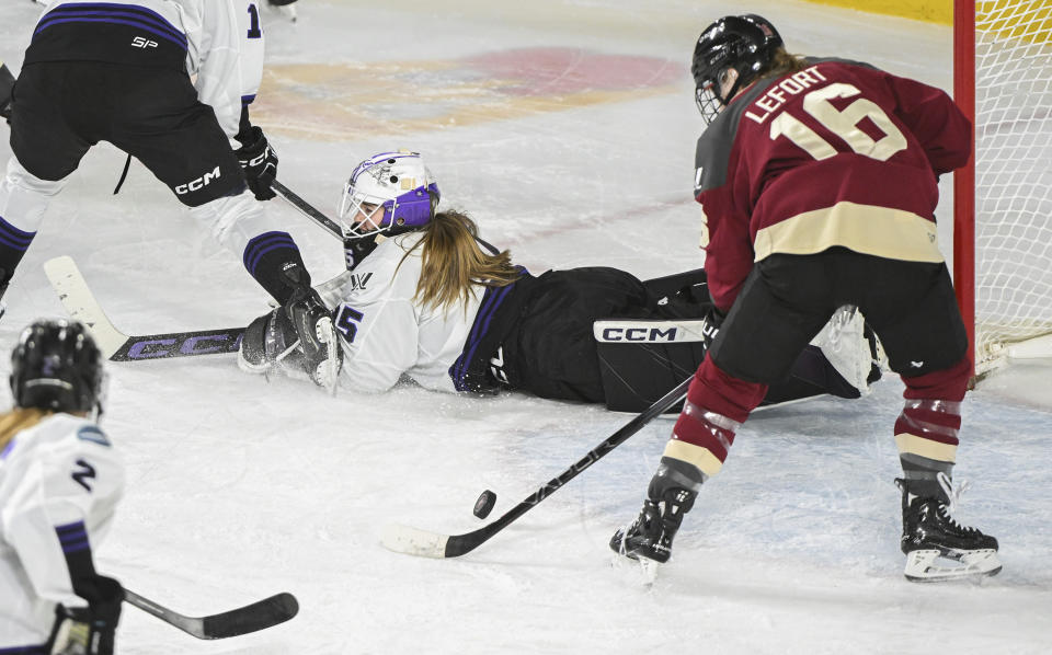 Montreal's Sarah Lefort (16) moves in to score on Minnesota goaltender Maddie Rooney during the second period of a PWHL hockey game in Laval, Quebec, Sunday, Feb. 18, 2024. (Graham Hughes/The Canadian Press via AP)