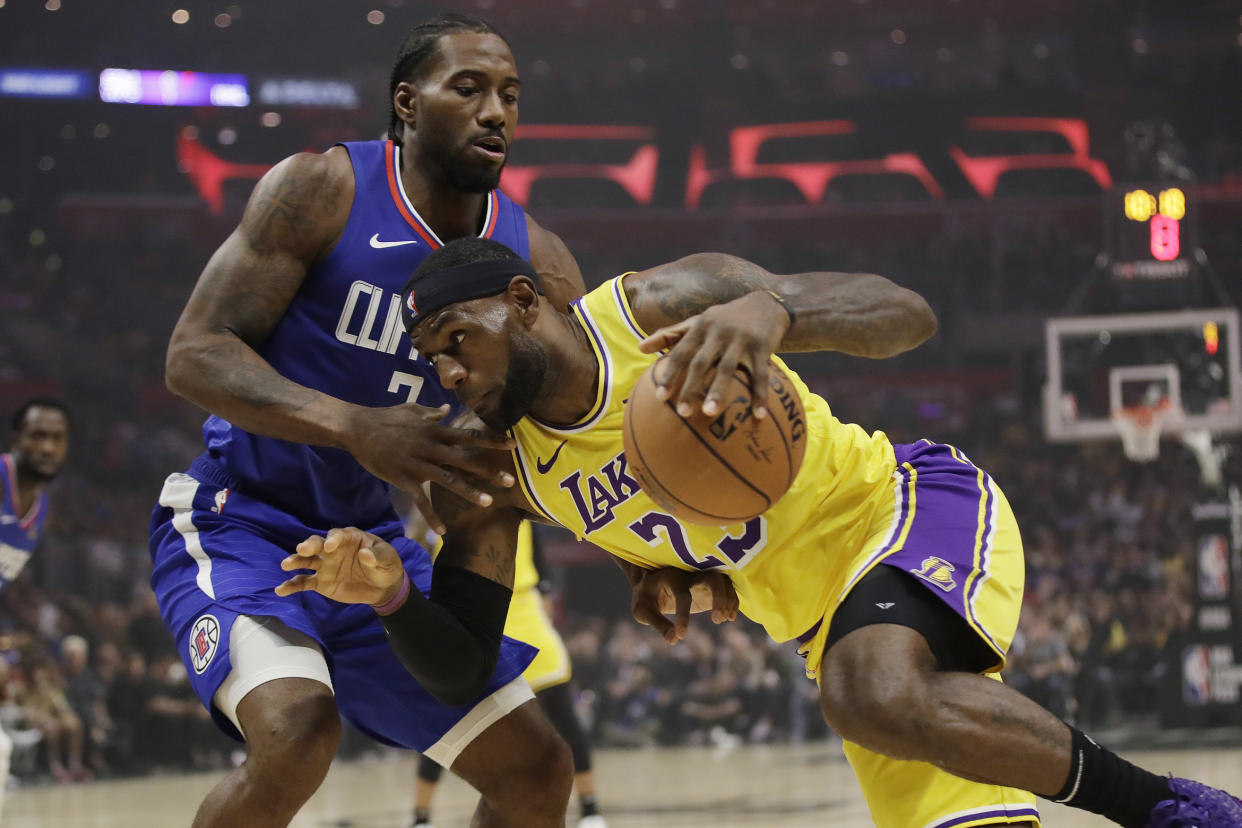 Los Angeles Lakers' LeBron James, right, is defended by Los Angeles Clippers' Kawhi Leonard during the first half of an NBA basketball game Tuesday, Oct. 22, 2019, in Los Angeles. (AP Photo/Marcio Jose Sanchez)