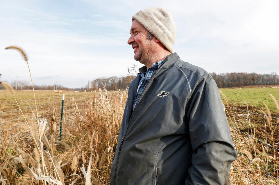 Gunthorp Farms owner Greg Gunthorp watches pigs roam around a pasture in LaGrange, Ind., Tuesday, Dec. 3, 2019. 