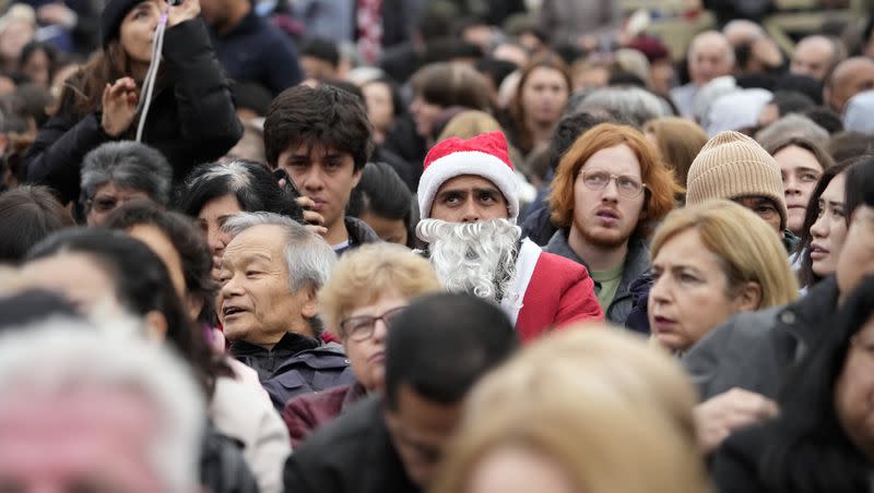 Faithful gather as they wait to listen to Pope Francis delivering the Urbi et Orbi (Latin for “to the city and to the world”) Christmas day blessing from the main balcony of St. Peter’s Basilica at the Vatican, Monday, Dec. 25, 2023.