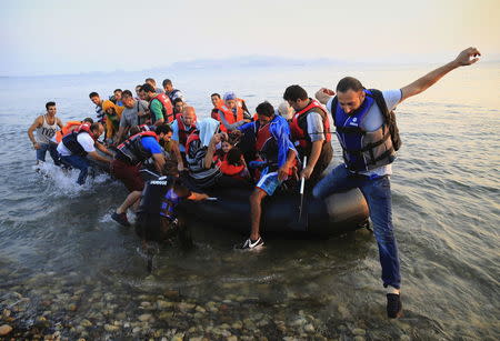 Syrian refugees arrive at a beach on the Greek island of Kos, August 11, 2015. REUTERS/Yannis Behrakis