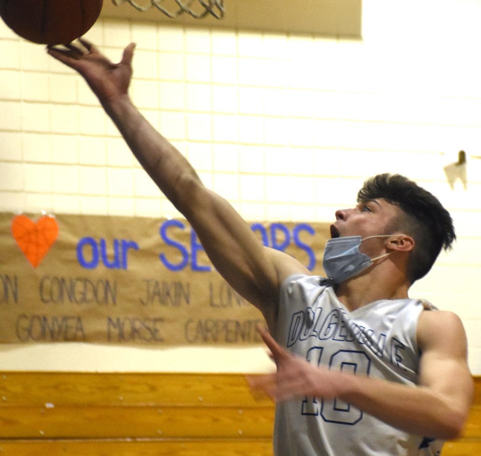 Kamryn Comstock lays the ball up for a Dolgeville basket Saturday during the second half of a 72-34 Section III playoff win over Sauquoit Valley. Comstock led the Blue Devils with 22 points and 15 rebounds.