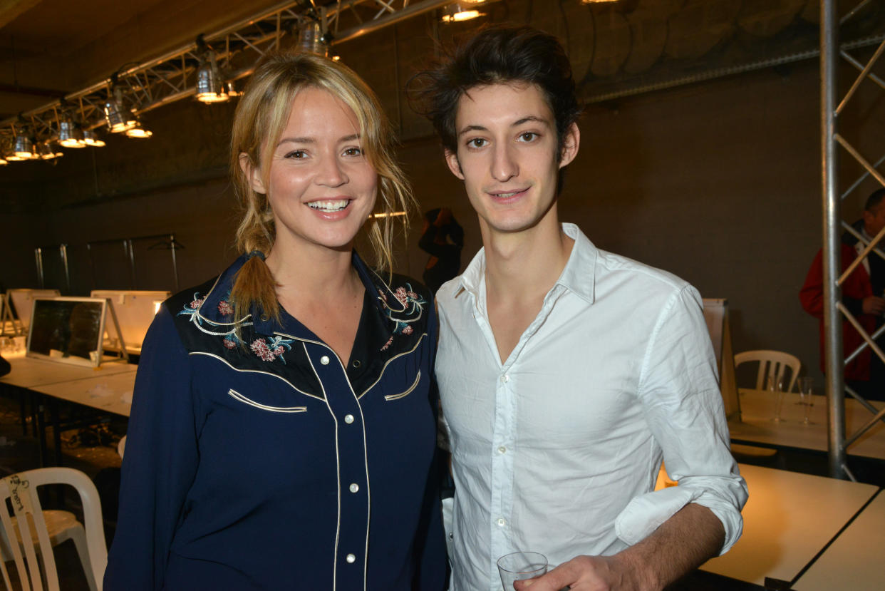 PARIS, FRANCE - SEPTEMBER 30:  Virginie Efira and Pierre Niney pose during the John Galliano: Front Row - Paris Fashion Week Womenswear Spring / Summer 2013 at Docks en Seine on September 30, 2012 in Paris, France.  (Photo by Foc Kan/WireImage)