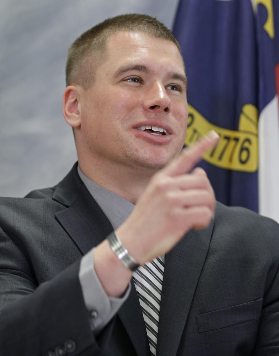 U.S. Army Specialist Kyle White smiles as he answers a question about his role during an ambush on his platoon in eastern Afghanistan that earned him the Medal of Honor during a news conference in Charlotte, N.C., Wednesday, April 23, 2014. (AP Photo/Chuck Burton)