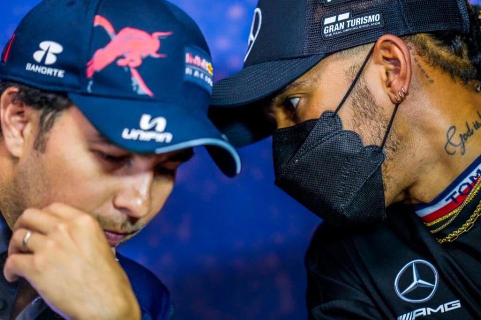 Mercedes driver Lewis Hamilton of Britain, right, talks with Red Bull driver Sergio Perez of Mexico during a press conference ahead of the French Formula One Grand Prix at the Paul Ricard racetrack in Le Castellet, southern France, Thursday, July 21, 2022. (AP Photo/Manu Fernandez)