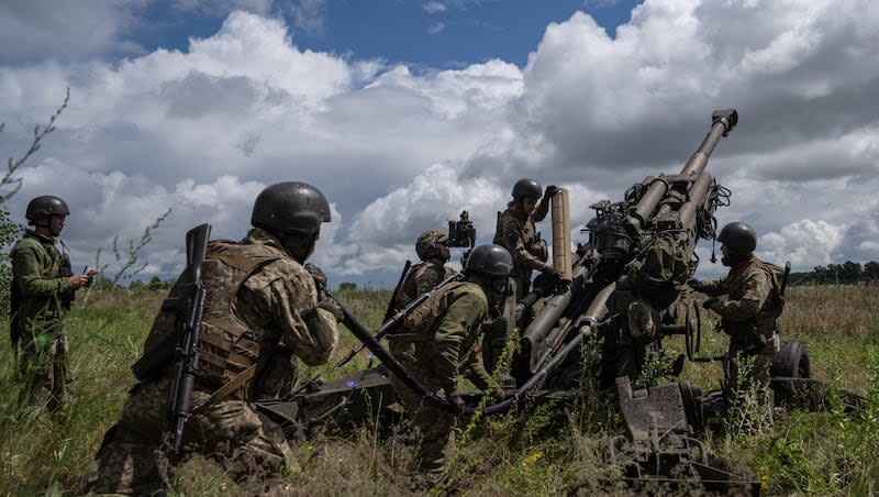 Ukrainian servicemen prepare to fire at Russian positions from a U.S.-supplied M777 howitzer in Kharkiv region, Ukraine, on July 14, 2022.