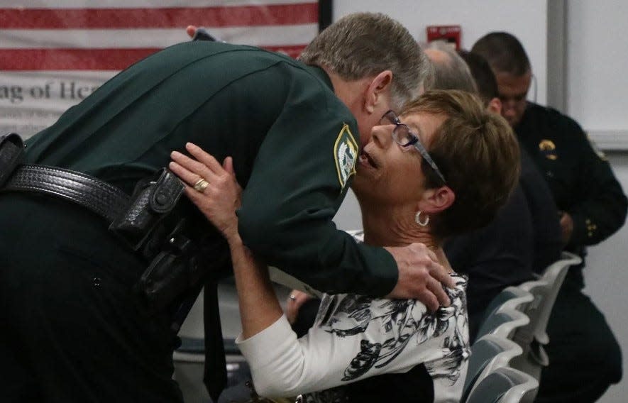 WESH-2 News reporter Claire Metz gives former Volusia County Sheriff Ben Johnson a hug at his retirement party in 2016. Johnson and other longtime public officials say Metz has been a trustworthy and knowledgeable journalist for decades.