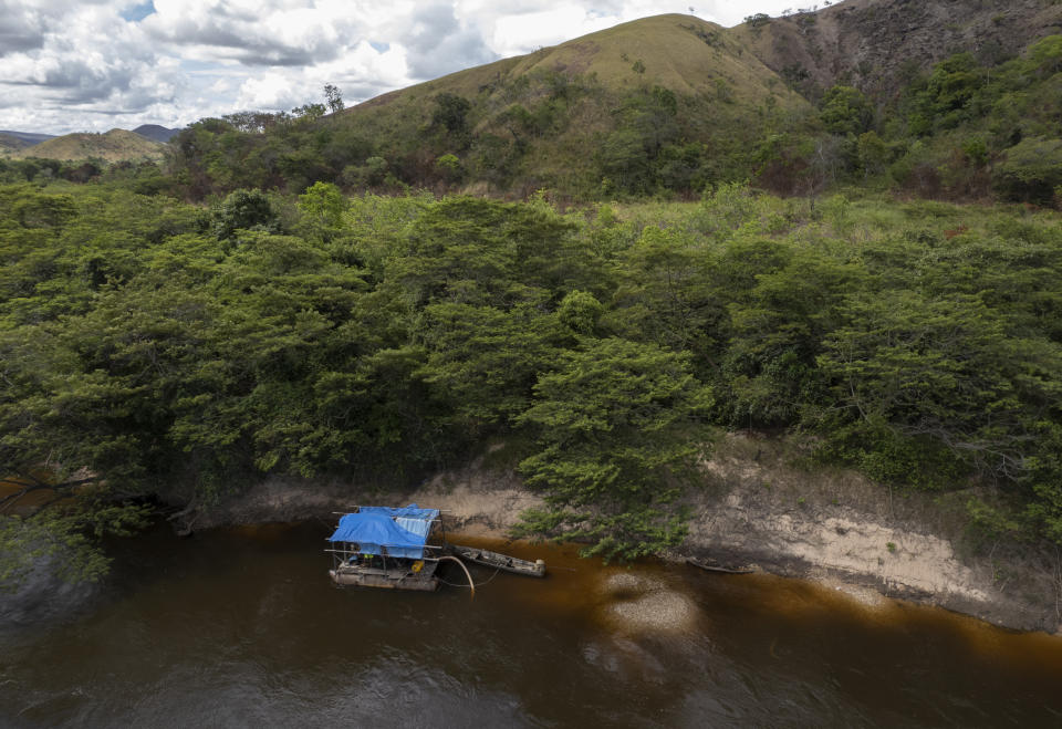 FILE - Illegal minors search for gold in the Ireng River on the Raposa Serra do Sol Indigenous reserve in Roraima state, Brazil, near the border with Guyana, Nov. 7, 2021. Like all Brazilians, residents of the vast Amazon region will elect governors and lawmakers in October’s general elections. Many politicians vie for who has a bolder promise to relax legal restrictions on gold mining, expand deforestation for agribusiness and pave highways through the forest. (AP Photo/Andre Penner, File)