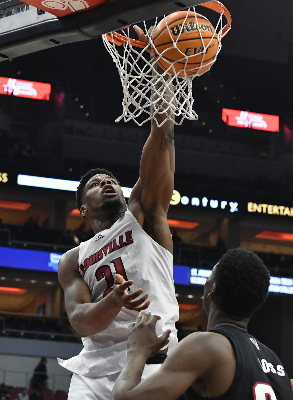 FILE - Louisville forward Sydney Curry (21) dunks over North Carolina State forward Ernest Ross during the second half of an NCAA college basketball game in Louisville, Ky., Wednesday, Jan. 12, 2022. The Cardinals return just one regular starter in Curry, a senior. (AP Photo/Timothy D. Easley, File)