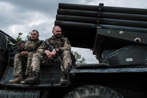 Ukrainian soldiers ride on a moving truck-mounted multiple rocket launcher near Lysychansk, eastern Ukraine on May 13, 2022. - More than six million refugees have fled Ukraine since Russia's invasion began on February 24, 2022, the UN refugee agency says. A total of 6,029,705 people had fled Ukraine as of May 11, with Poland hosting the largest number. Women and children represent 90 percent of the refugees. (Photo by Yasuyoshi CHIBA / AFP) (Photo by YASUYOSHI CHIBA/AFP via Getty Images) ORG XMIT: 0 ORIG FILE ID: AFP_32A29XH.jpg