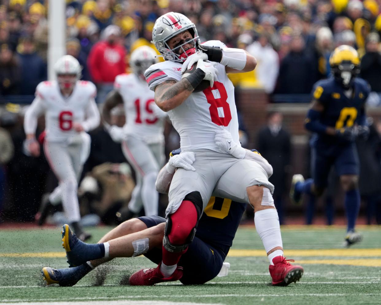 Cade Stover gets taken down after a catch against the Michigan Wolverines.