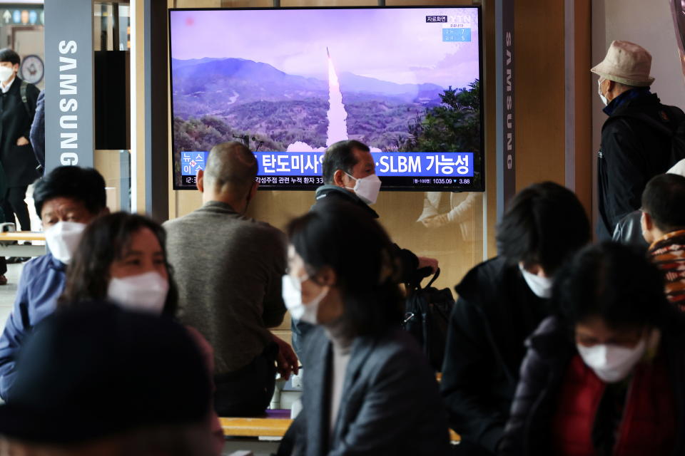 South Koreans watch a TV broadcasting file footage of a news report on North Korea firing a ballistic missile off its east coast. Source: Reuters