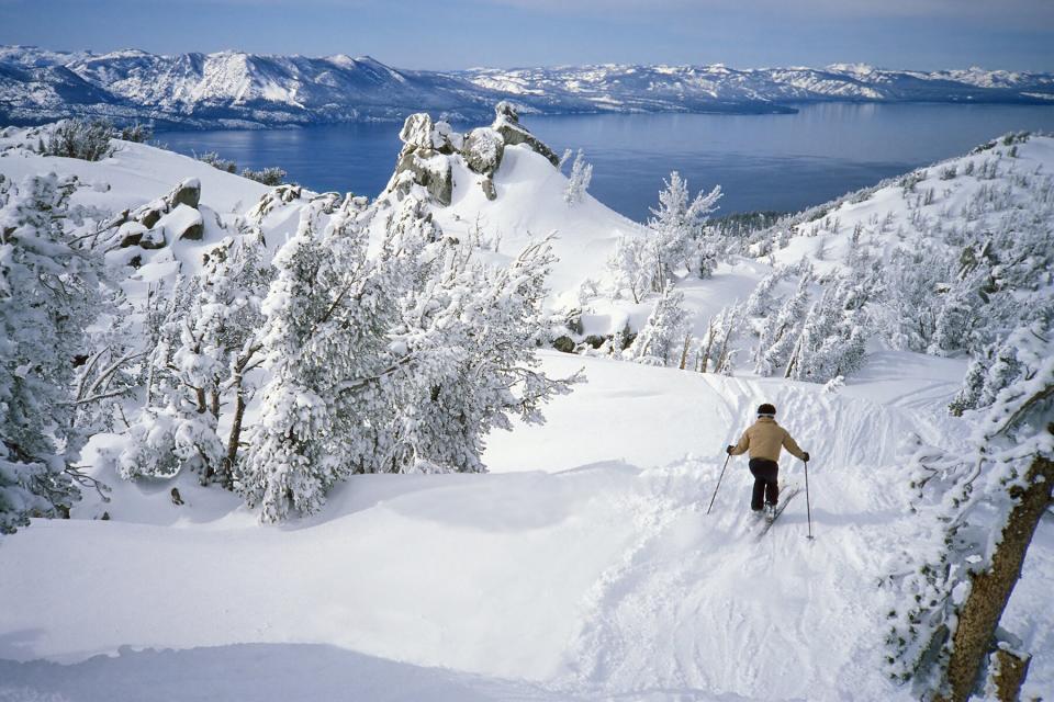 Skier in Fresh Snow Above Alpine Lake Tahoe