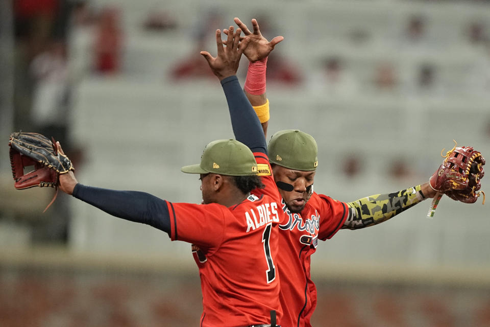 Atlanta Braves' Ronald Acuna Jr., right, and Ozzie Albies, left, celebrate after a win over the Seattle Mariners, Friday, May 19, 2023, in Atlanta. (AP Photo/Brynn Anderson)