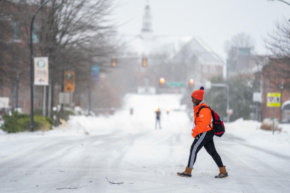 A young woman walks along Main St. on January 16, 2022, in Greenville, South Carolina. More than 4 inches of snow from Winter Storm Izzy has fallen with more sleet and freezing rain expected in the area for the remainder of the day. / Credit: Sean Rayford / Getty Images