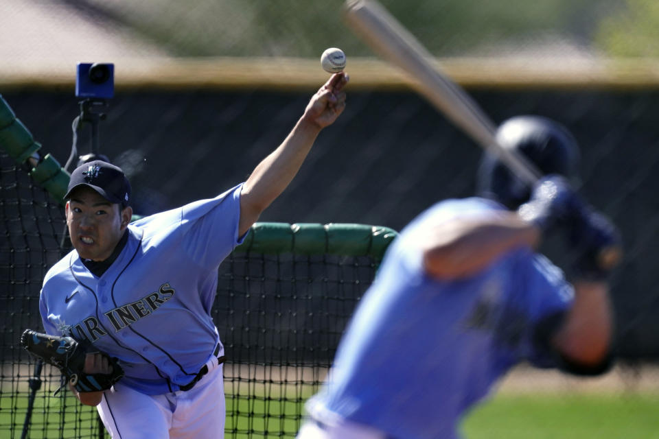 Seattle Mariners pitcher Yusei Kikuchi, from Japan, throws during spring training baseball practice Thursday, Feb. 25, 2021, in Peoria, Ariz. (AP Photo/Charlie Riedel)