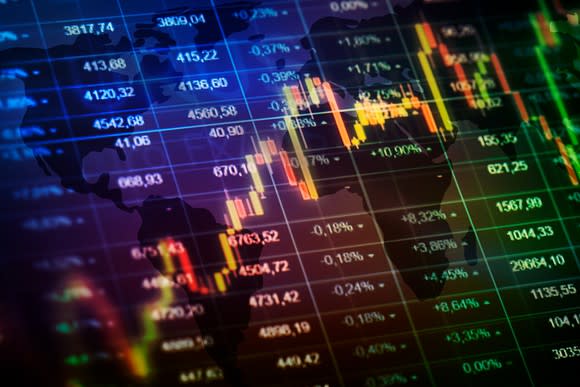 Stock chart and spreasheet superimposed over global map.